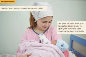 A mother lovingly holds her newborn baby, wrapped in a pink blanket and wearing a blue cap. Text overlays emphasize the importance of the first breastfeed, advising mothers to ask their midwife to allow immediate breastfeeding for the baby's best start in life.